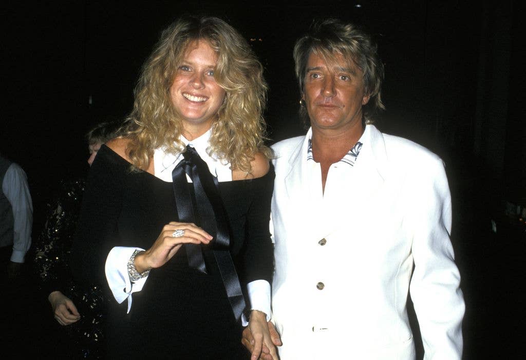 Rachel Hunter walking with Rod Stewart