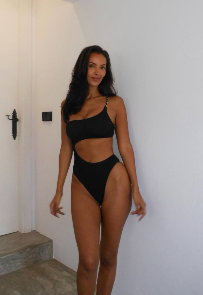 A photo of Maya Jama wearing a black cut-out swimsuit