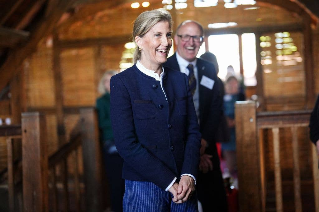 The Duchess of Edinburgh smiling in navy jacket