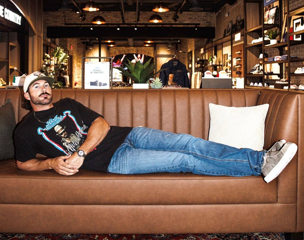 Riley kicked back on a sofa in the store in his new shoes