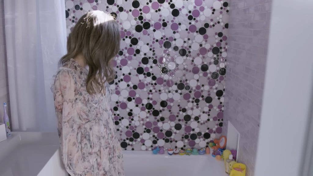 Robert Downey Jr.'s wife in a purple bathroom