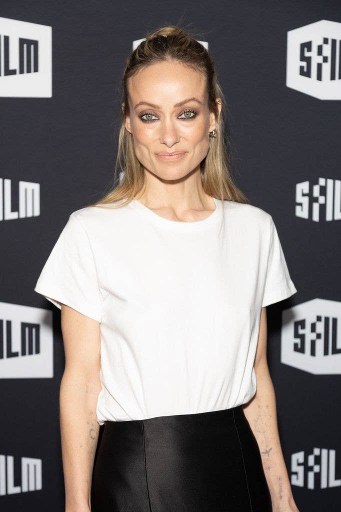 Olivia appeared effortlessly chic in a crisp white T-shirt paired with a flowing black satin skirt 