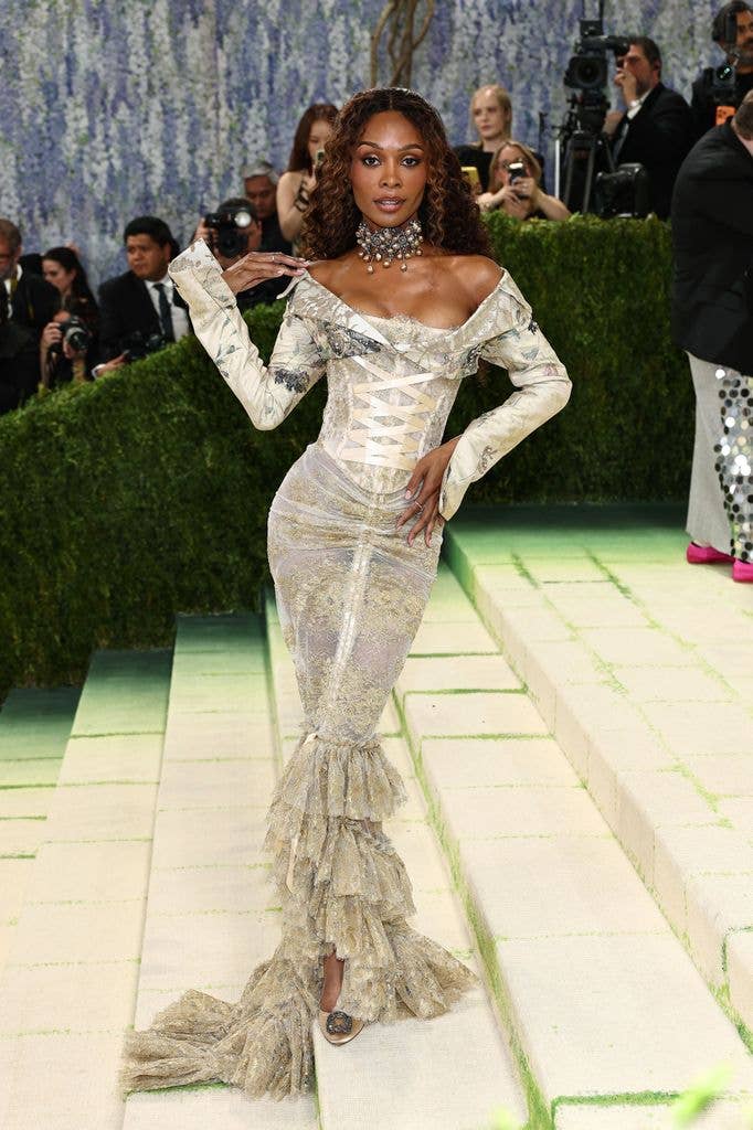 Zuri Hall wears a metallic off the shoulder dress with ruffled hem