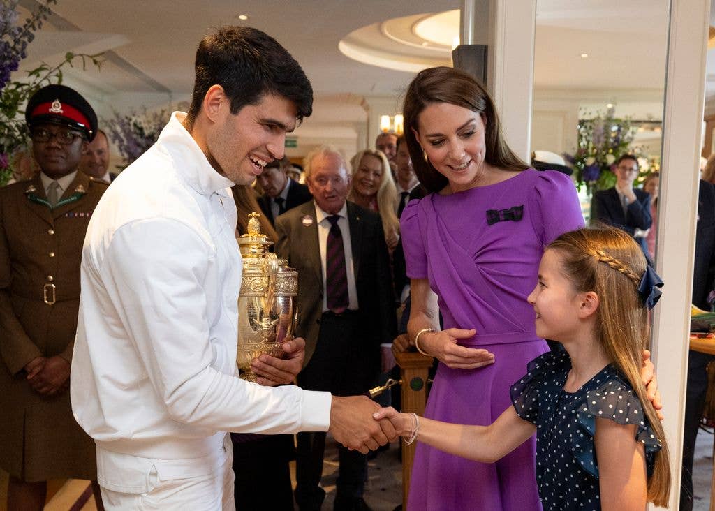 Carlos Alcaraz shakes hands with Princess Charlotte in the Clubhouse following his victory against Novak Djokovic 