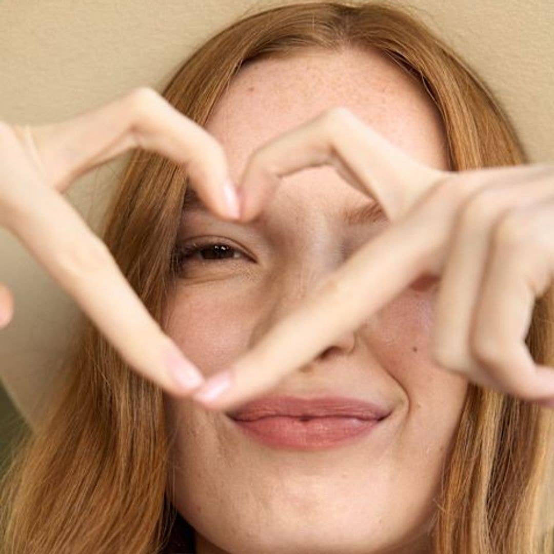 Model doing a heart sign and showing one eye 