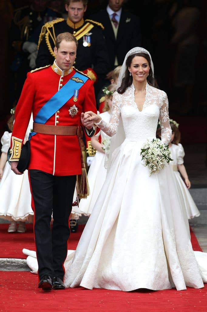 Prince William and Princess Kate smile as they walk out of Westminster Abbey following their wedding.