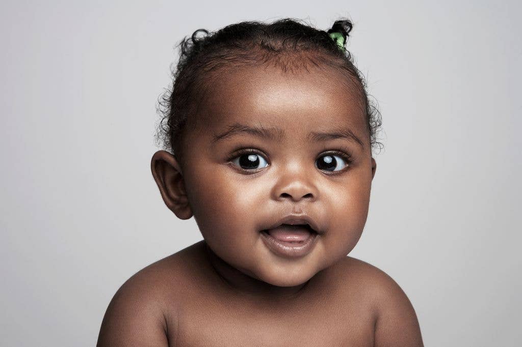 Baby girl  (6-9 months) smiling, portrait