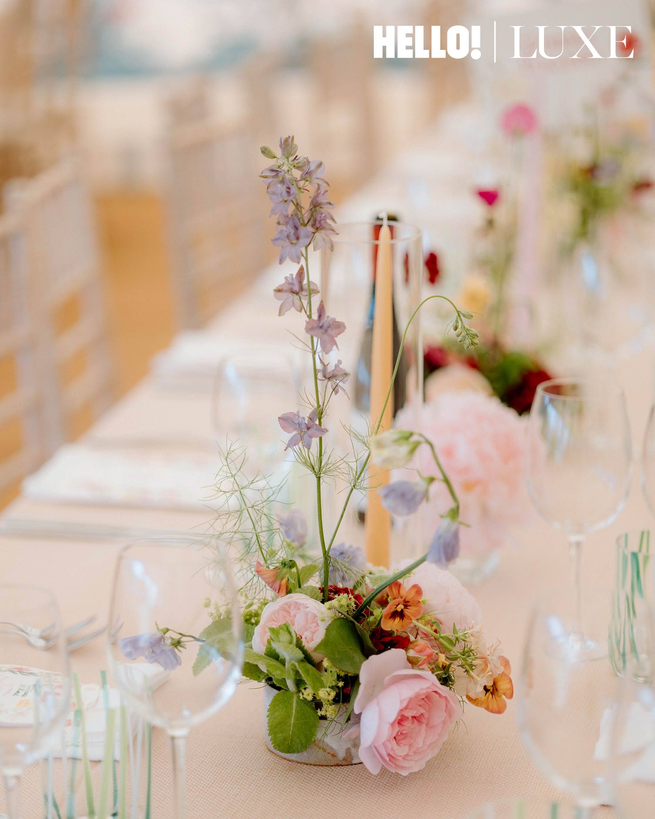 A close-up of the seasonal, locally sourced floral arrangements by florist Fran Smith, featuring pink roses and tall stems of purple delphiniums