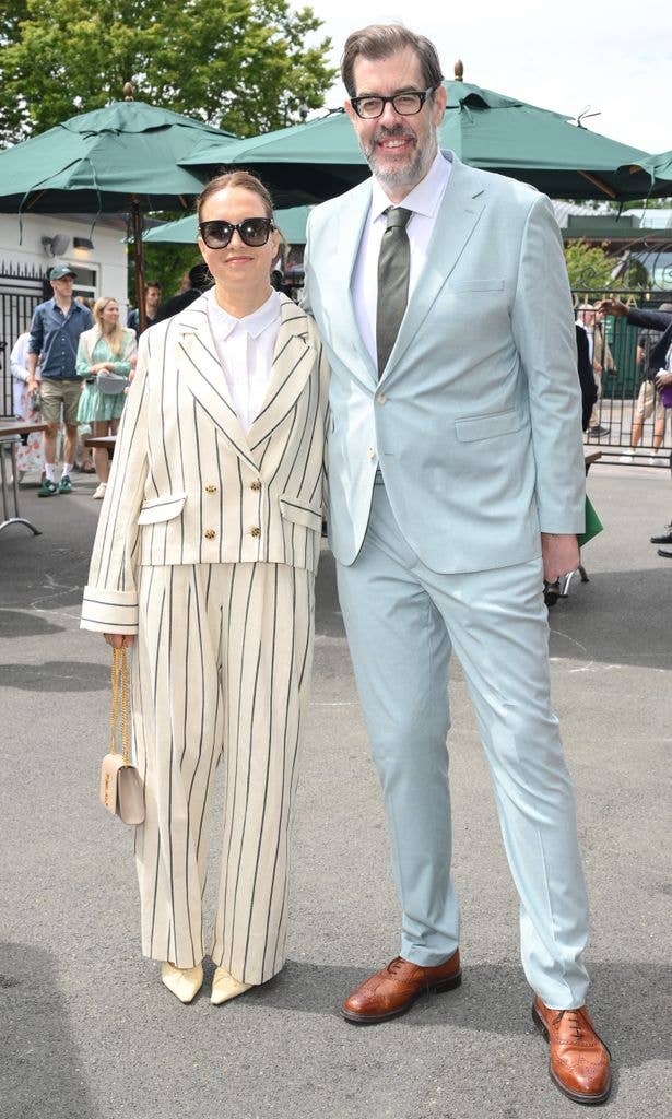 Richard Osman and Ingrid Oliver standing together, both smiling, at Wimbledon