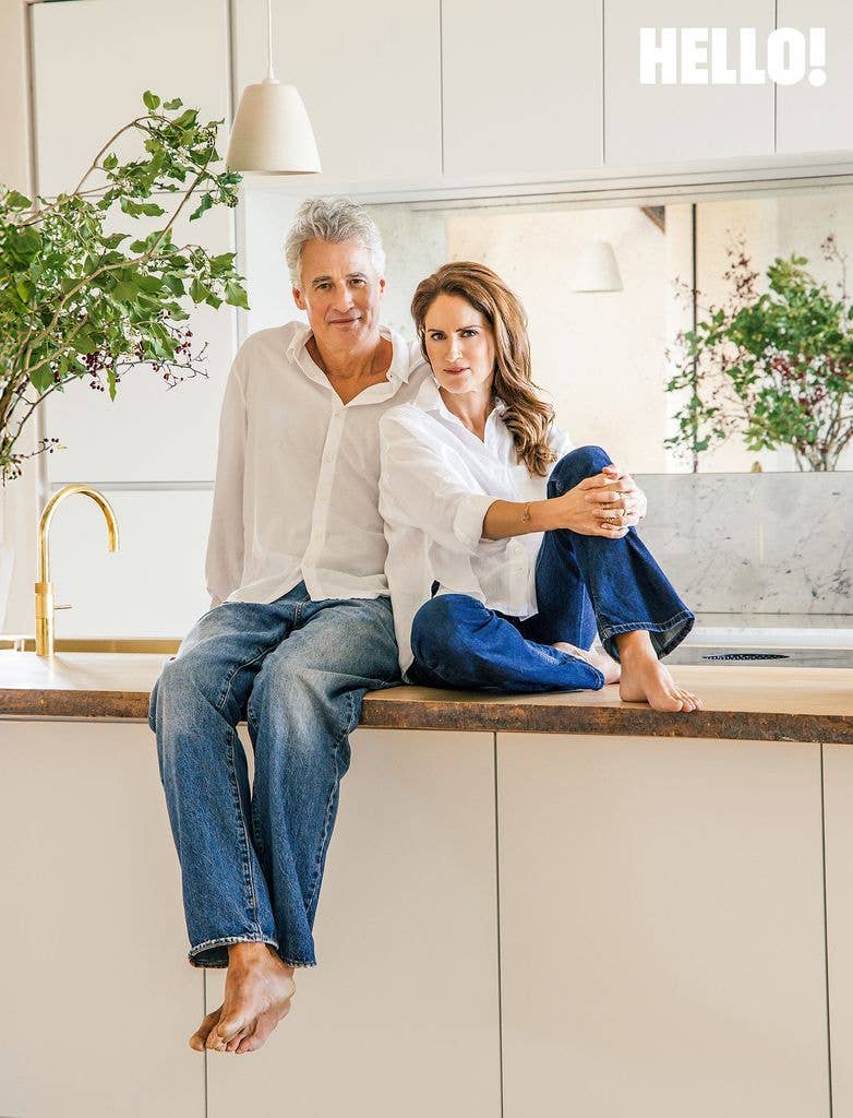 Alex and Susanna posing on their oak kitchen worktop in their Cotswolds Leaf House