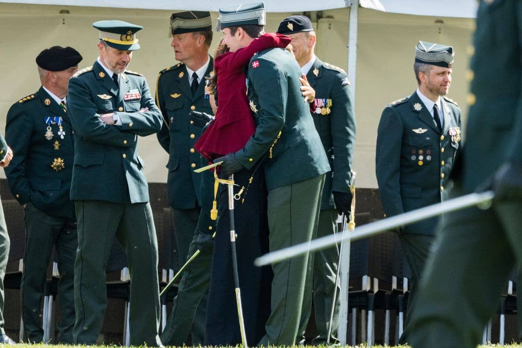 Queen Mary of Denmark hugging Crown Prince Christian 