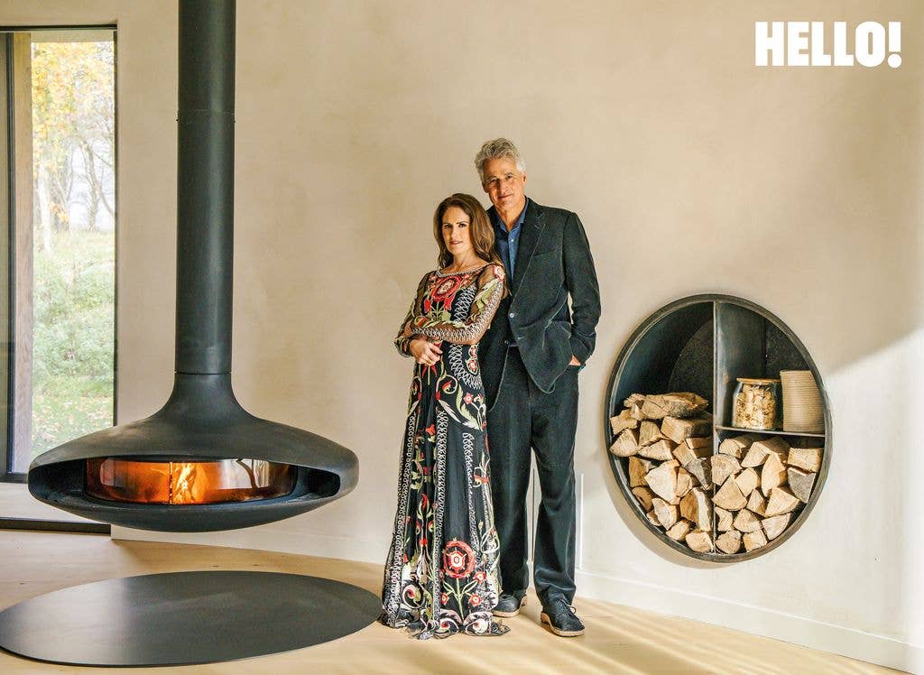 Alex and Susanna standing by a Gyrofocus fireplace in their Cotswolds Leaf House