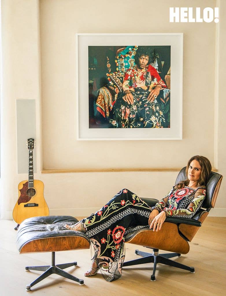 Susanna rests on a classic Eames lounge chair in her Cotswolds Leaf Home
