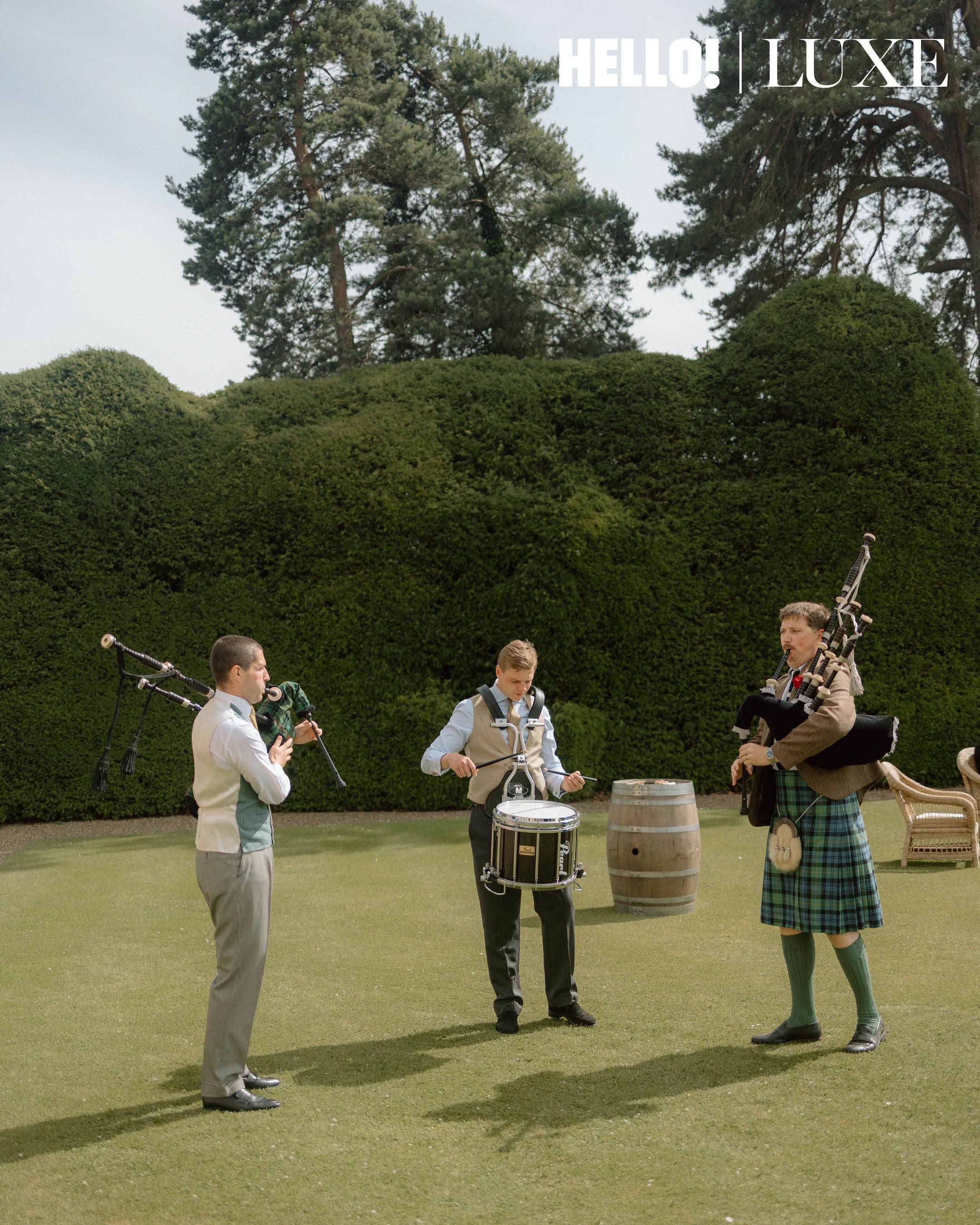Three of Nico’s school friends play the bagpipes and drum on the lawns of Hovingham Hall to kick off the reception celebrations