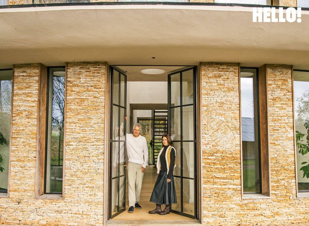 Alex Michaelis and his wife Susanna Parry stand by the front doors of Leaf House