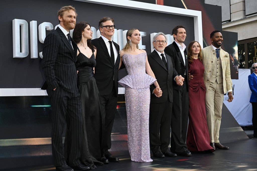 (L-R) Wyatt Russell, Eve Hewson, Colin Firth, Emily Blunt, Steven Spielberg, Josh O'Connor and Colman Domingo 