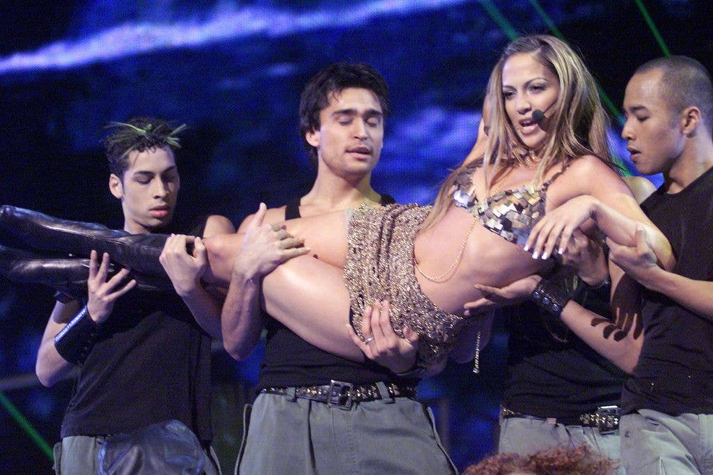 Jennifer Lopez on stage in a sparkley bikini and black boots at the Billboard Music Awards 1999.