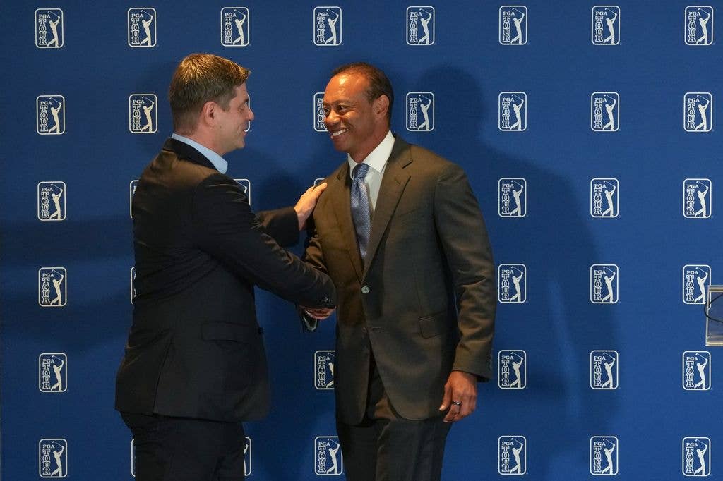 Tiger Woods shakes hands with Brian Rolapp, CEO of the PGA TOUR, during an announcement of a new competitive model to the PGA TOUR, prior to Travelers Championship at TPC River Highlands on June 23, 2026 in Cromwell, Connecticut.