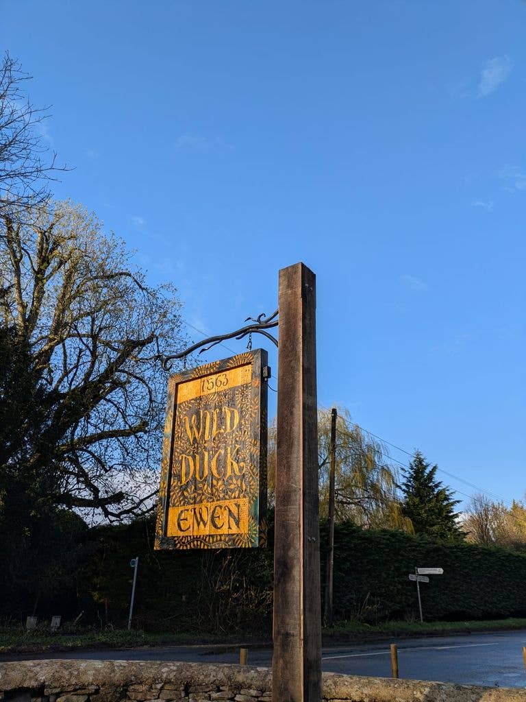 pub sign against a blue sky