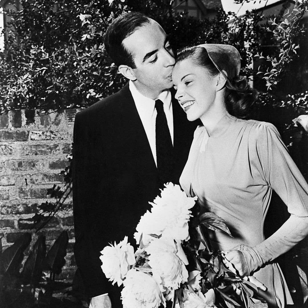 1945:  Film director Vincente Minnelli (1903 - 1986) kisses singer and actress Judy Garland (1922 - 1969) on the brow at their wedding