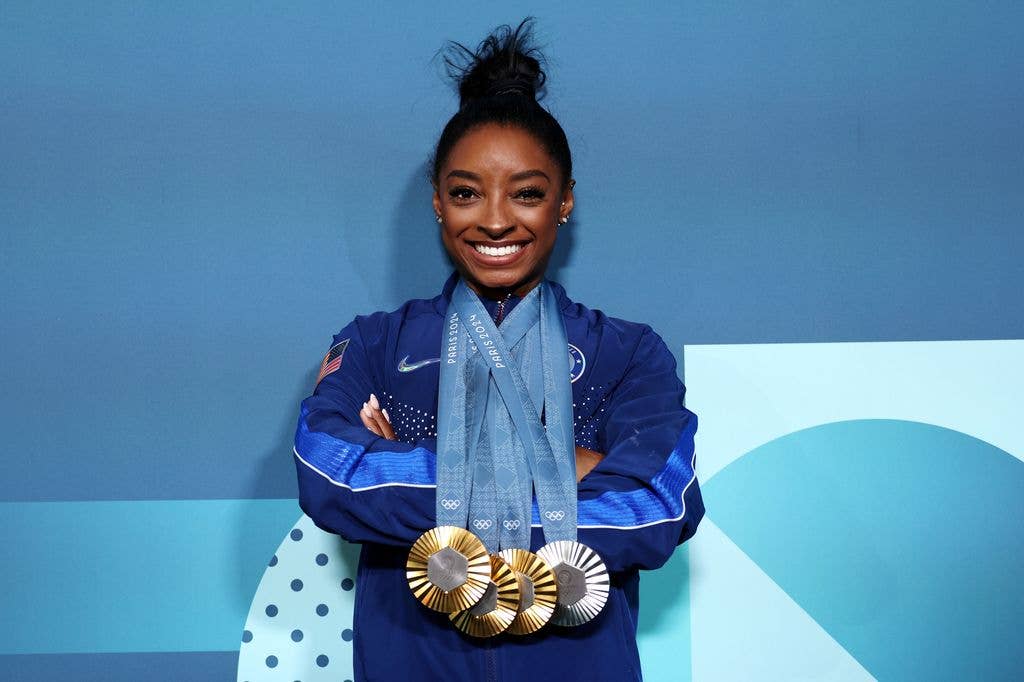 Simone Biles of Team United States poses with her Paris 2024 Olympic medals following the Artistic Gymnastics Women's Floor Exercise Final on day ten of the Olympic Games Paris 2024 at Bercy Arena on August 05, 2024 in Paris, France. 