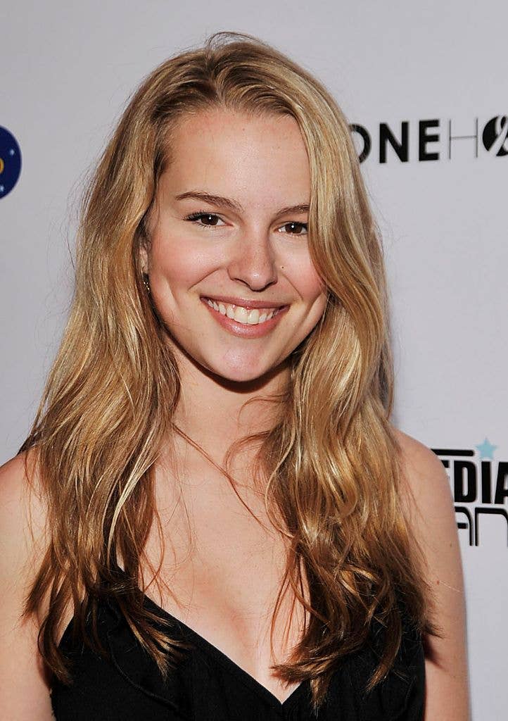Bridget Mendler in a black v neck dress.