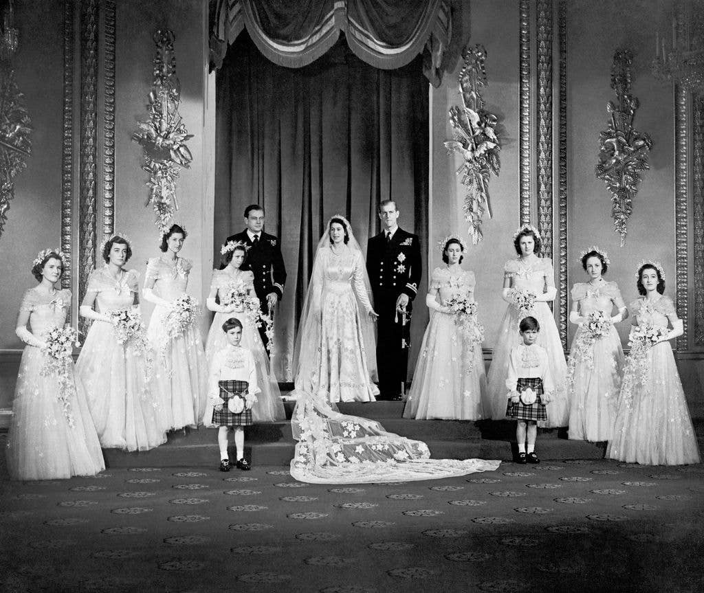 Princess Elizabeth and the Duke of Edinburgh with their eight bridesmaids in the Throne Room at Buckingham Palace