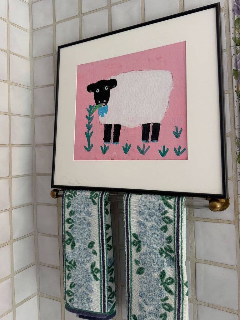 A quirky framed pic with pretty hand towels