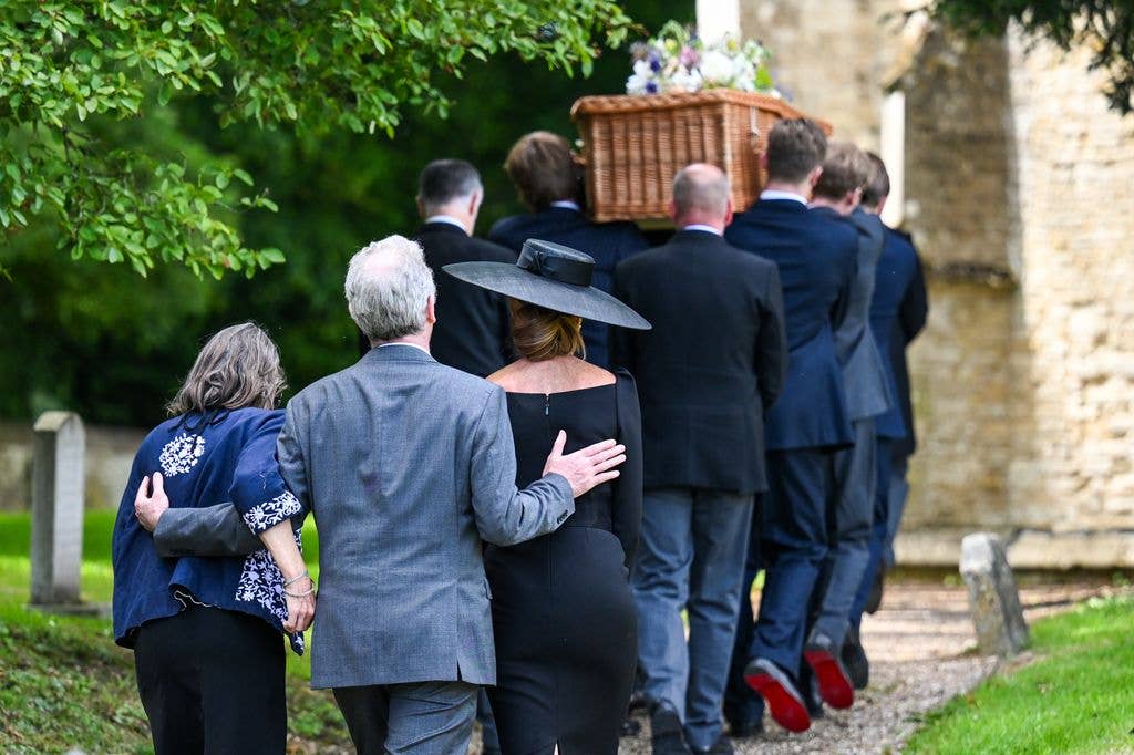 A coffin being carried into a church