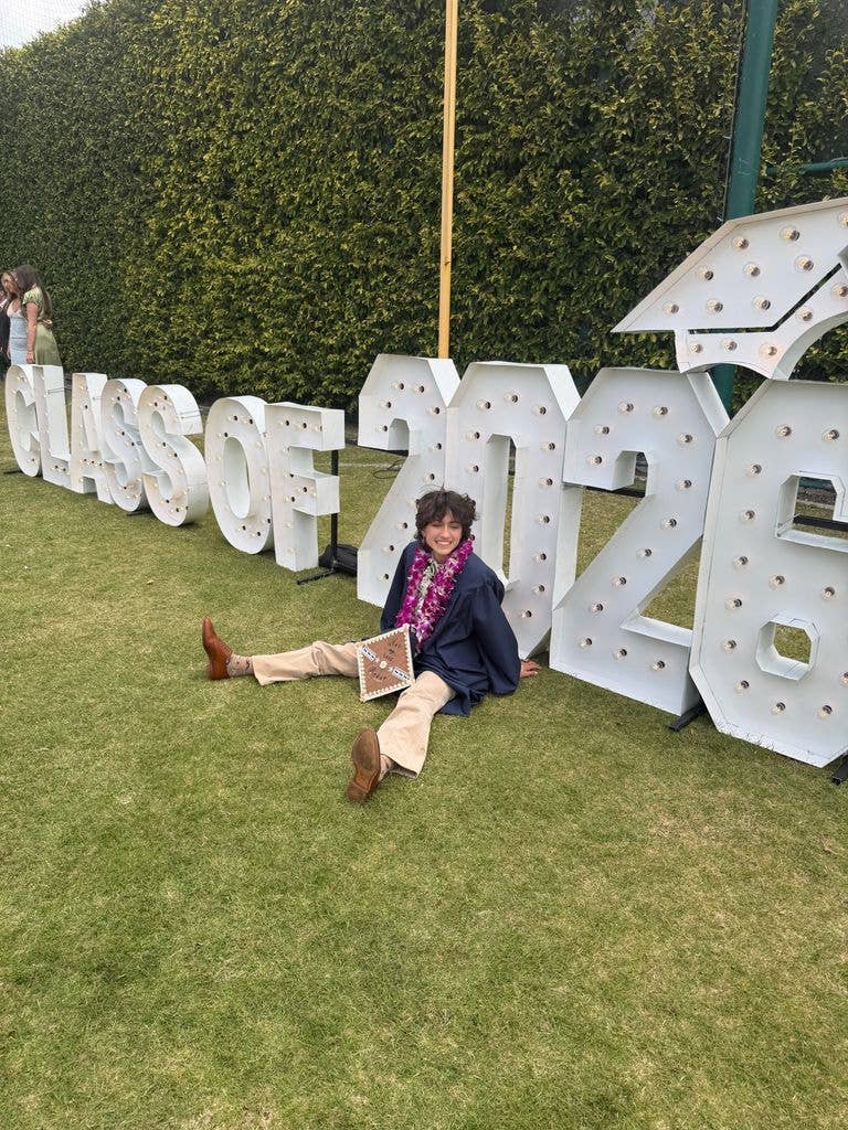 Jennifer Lopez's child Oskar poses beside a sign reading "Class of 2026" during their graduation ceremony, shared on Instagram