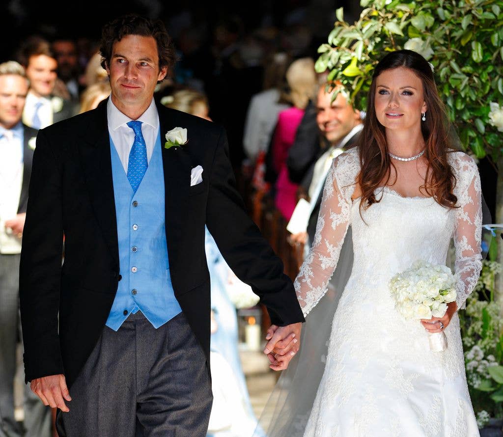 Rupert Finch and Lady Natasha Rufus Isaacs leave the church of St John the Baptist after their wedding