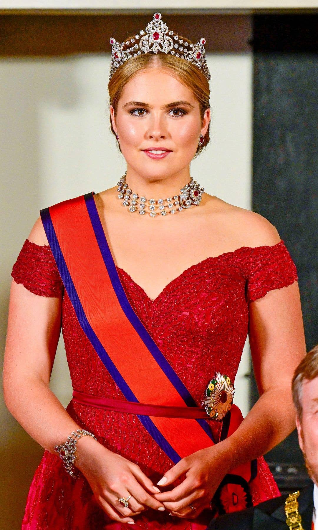Princess Catharina Amalia standing in a red dress and ruby tiara