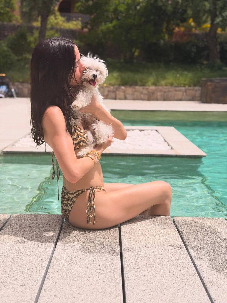 ana de armas bikini by the pool holding dog