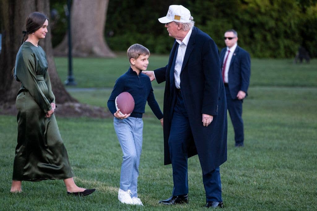 President Donald Trump greets grandson Theodore 
