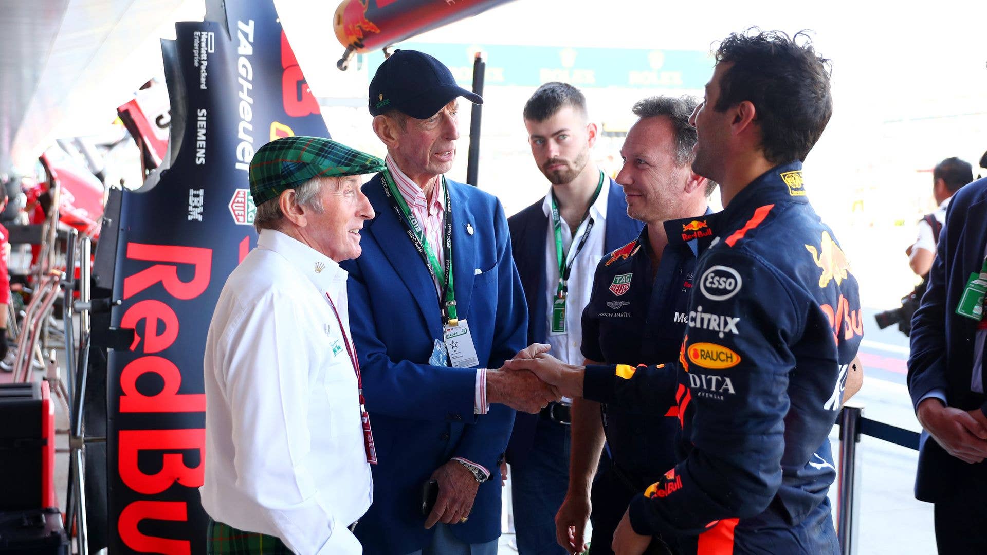 Jackie Stewart and the Duke of Kent chatting with Christian Horner and Daniel Ricciardo