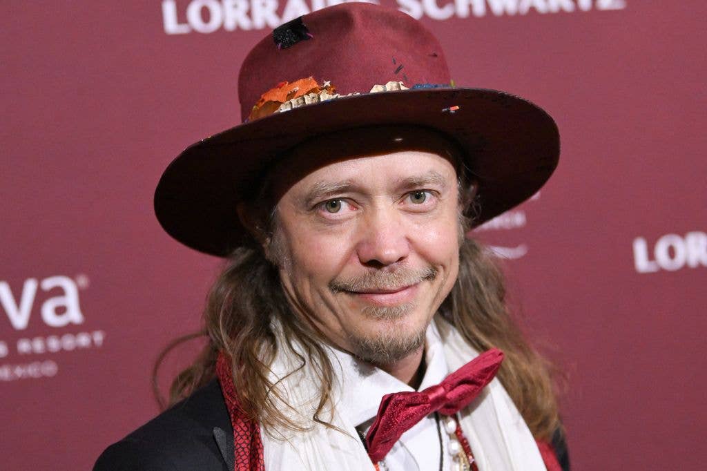 Brock Pierce in a red hat and suit in 2025 at the Annual Angel Ball.