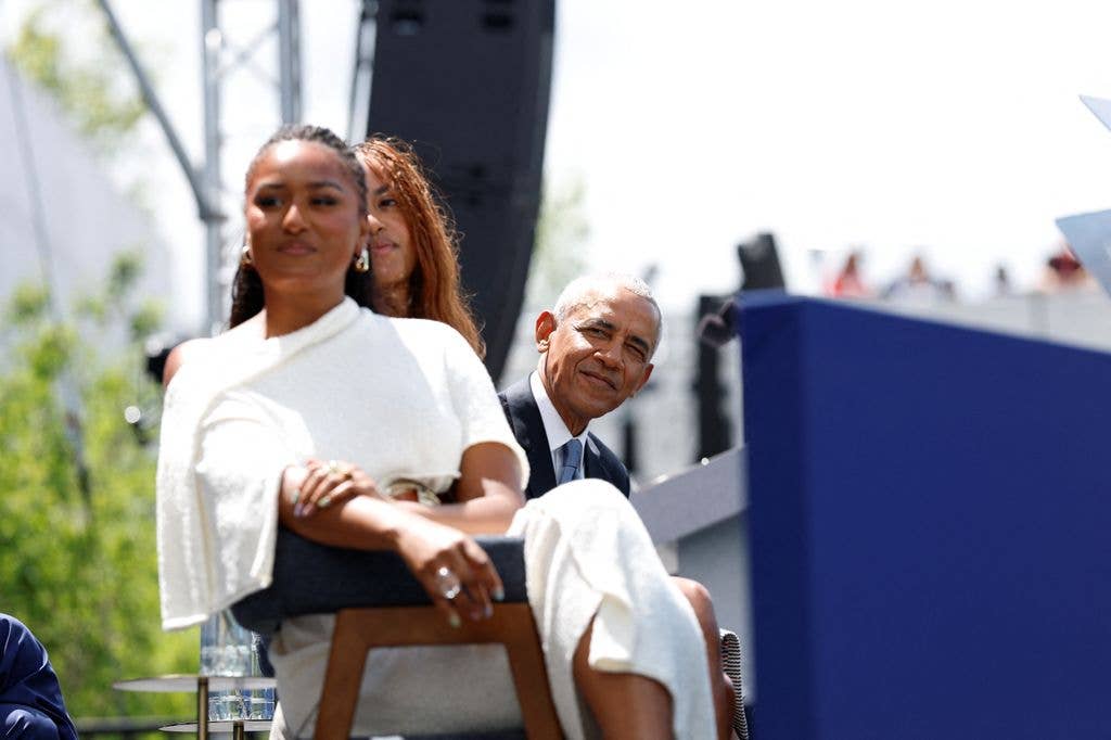 Barack's daughters Malia and Sasha made a rare appearance to support their parents
