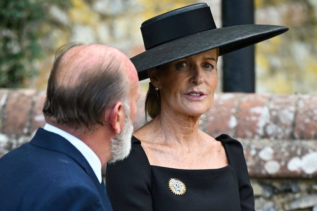 India Hicks being supported by a man at a funeral