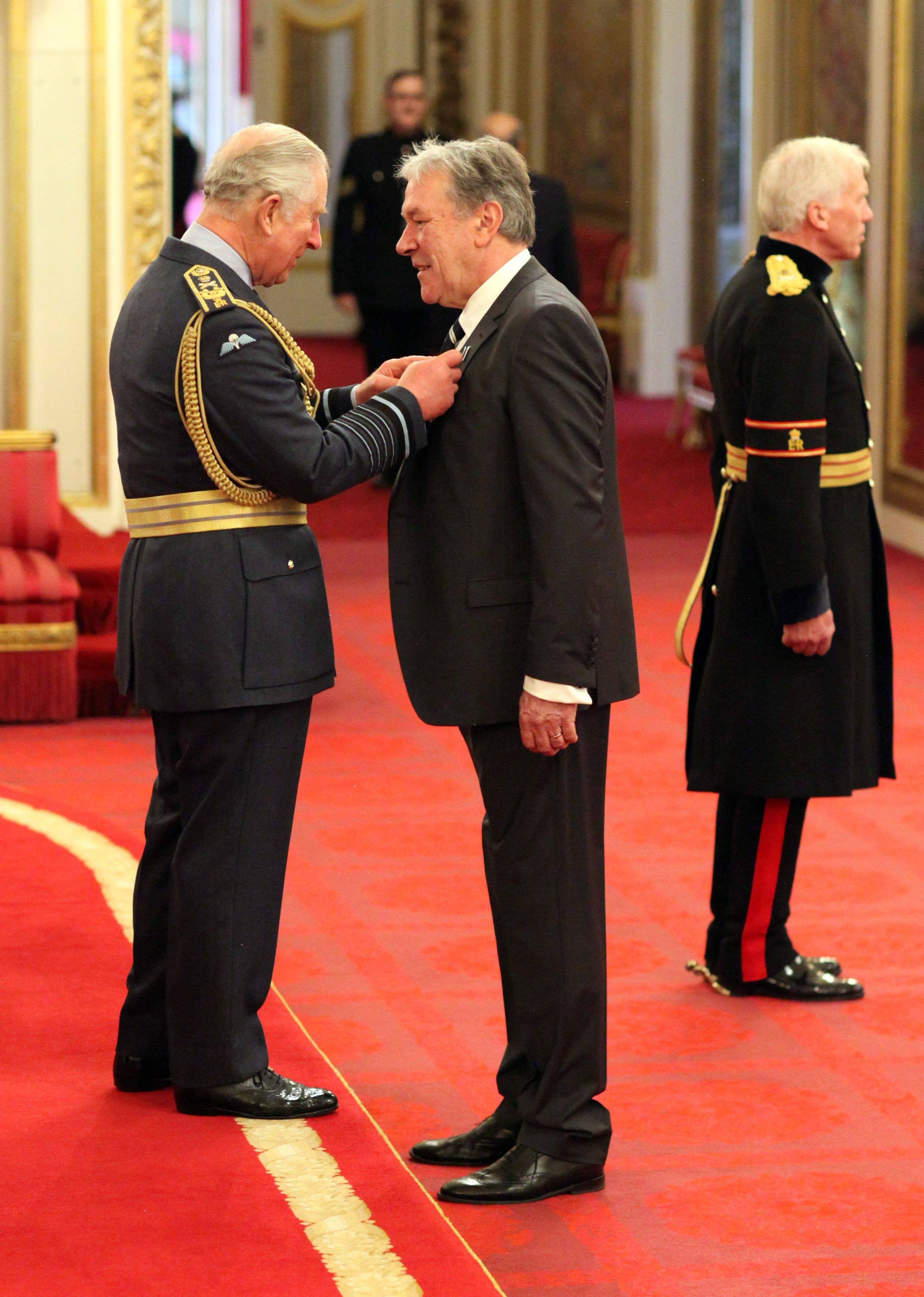 Tim Bentinck (right) is made an MBE by the King, then Prince of Wales at Buckingham Palace in 2018