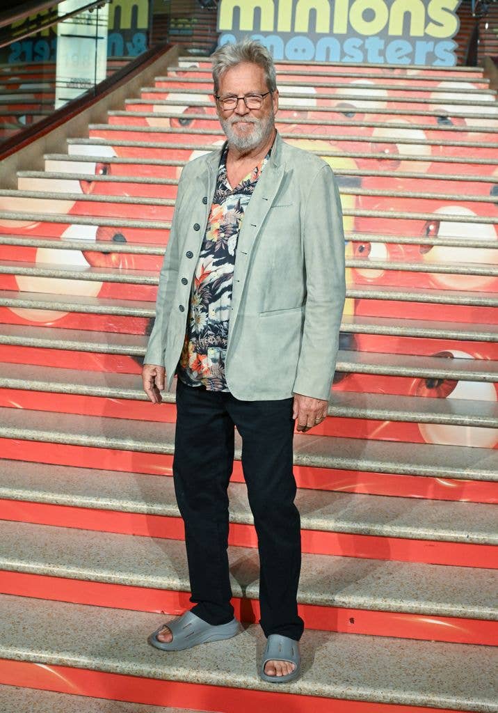 Jeff sporting a relaxed look with a floral Hawaiian shirt layered beneath a pale sage suede jacket