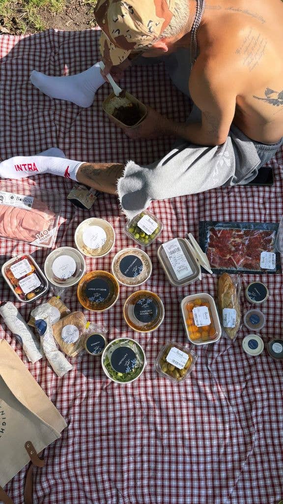 A photo of snacks on a red and white chequered picnic blanket