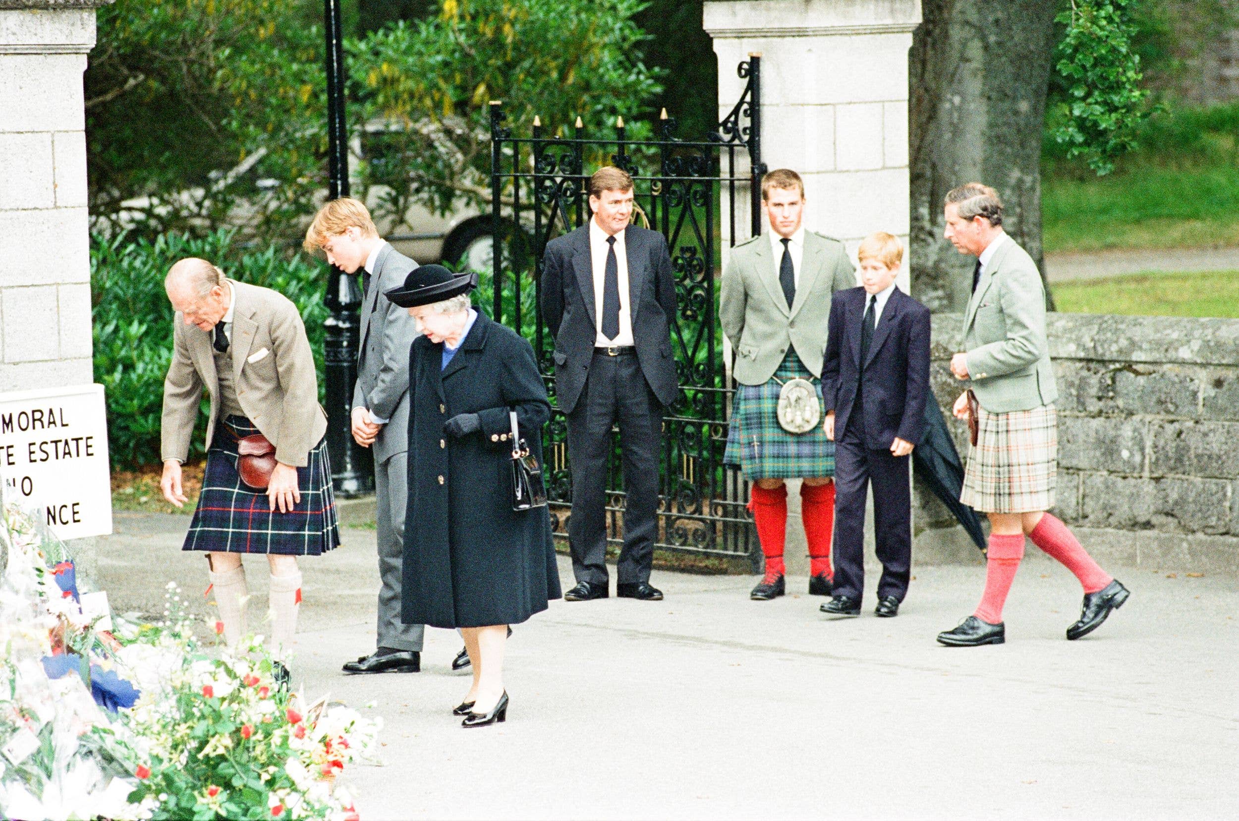 The royal family stop to look at floral tributes left for Princess Diana, at the gates of Balmoral Castle, in 1997