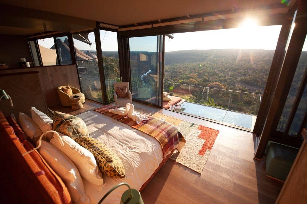 A bed overlooking a wilderness reserve
