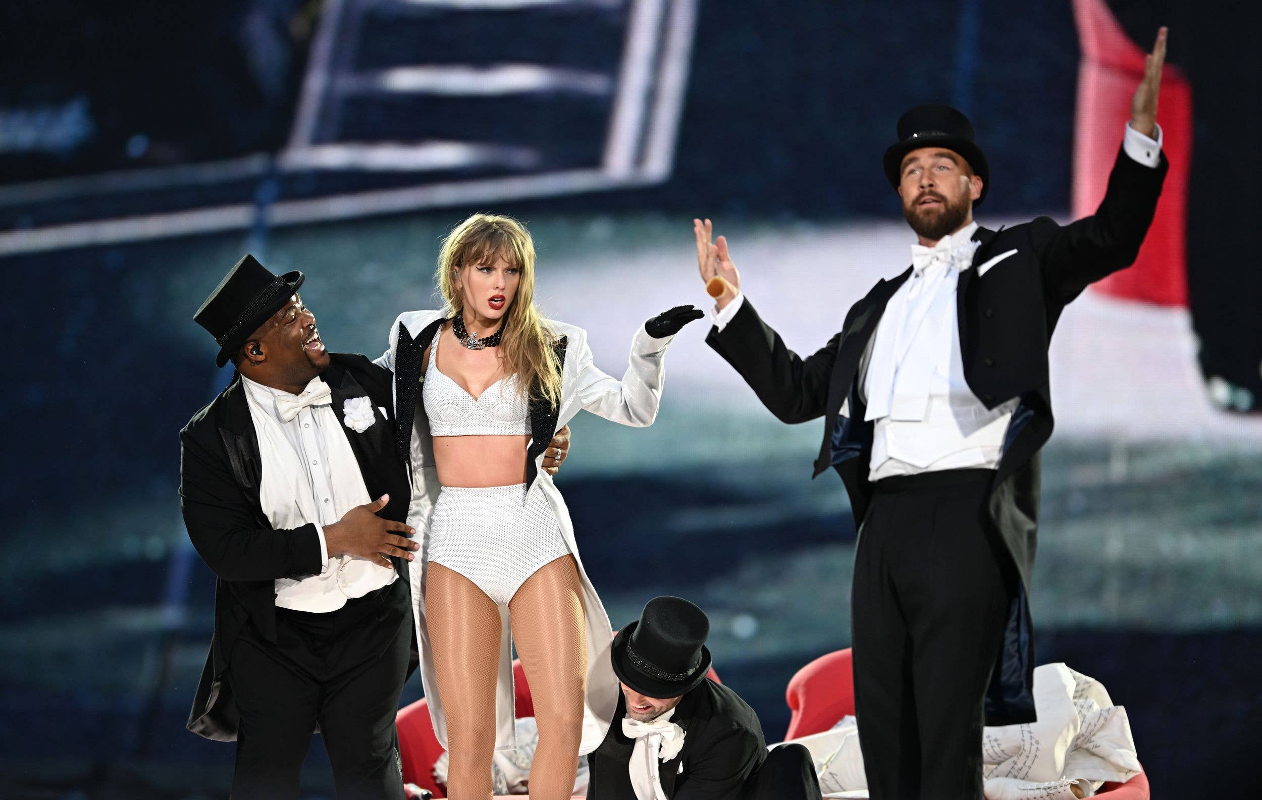Taylor Swift is joined on stage by Travis Kelce (R), during "Taylor Swift | The Eras Tour" at Wembley Stadium on June 23, 2024 in London, England