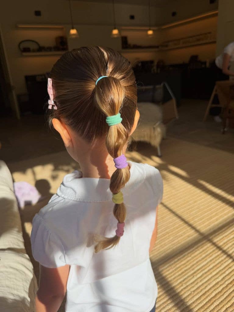 A photo of a blonde ponytail with colourful hairbands 