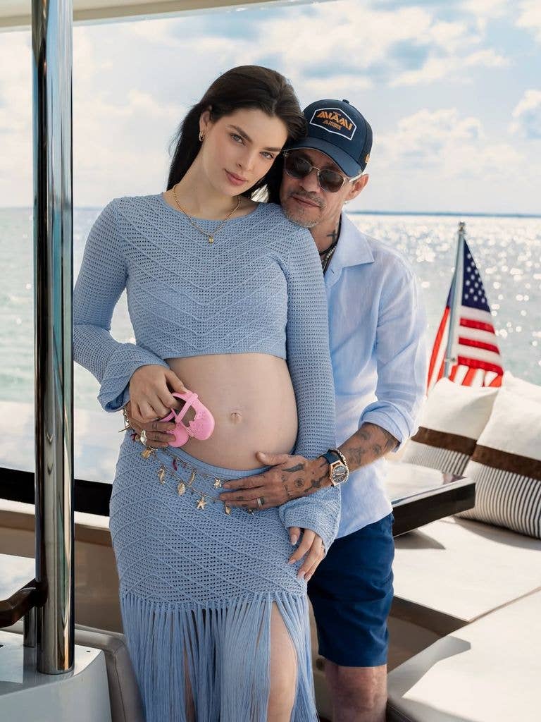Marc Anthony and Nadia posing on boat in matching blue outfits