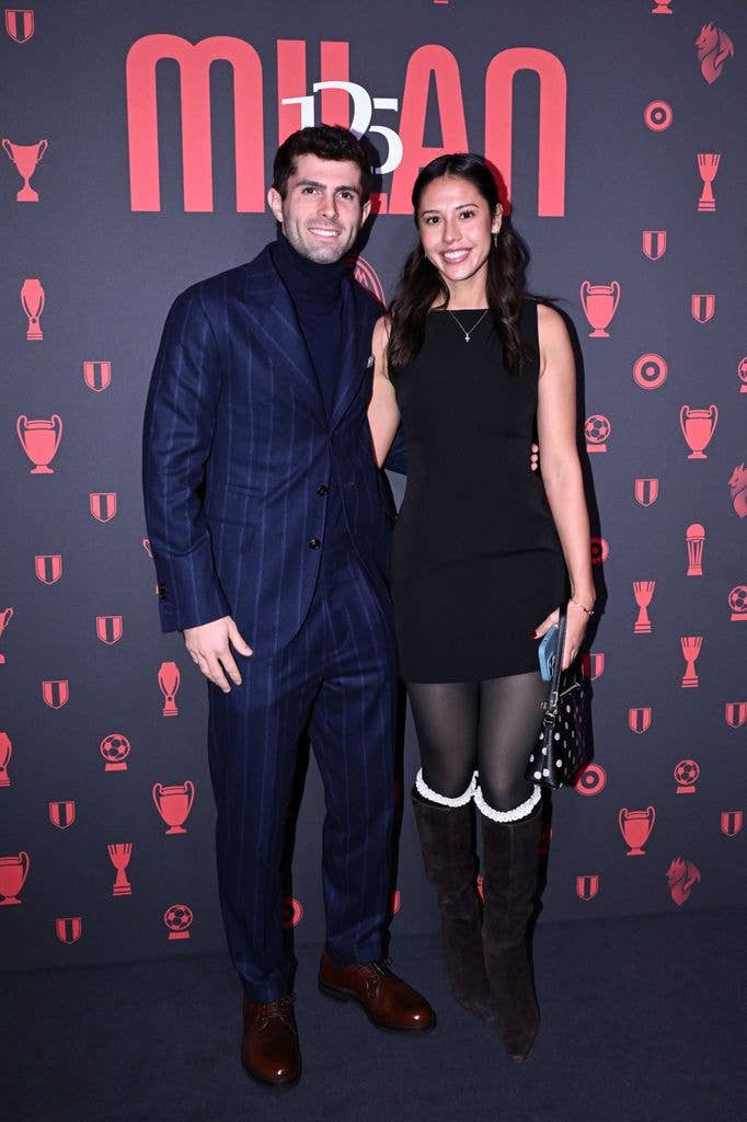 Christian Pulisic in suit and Alexa Melton in black dress 
