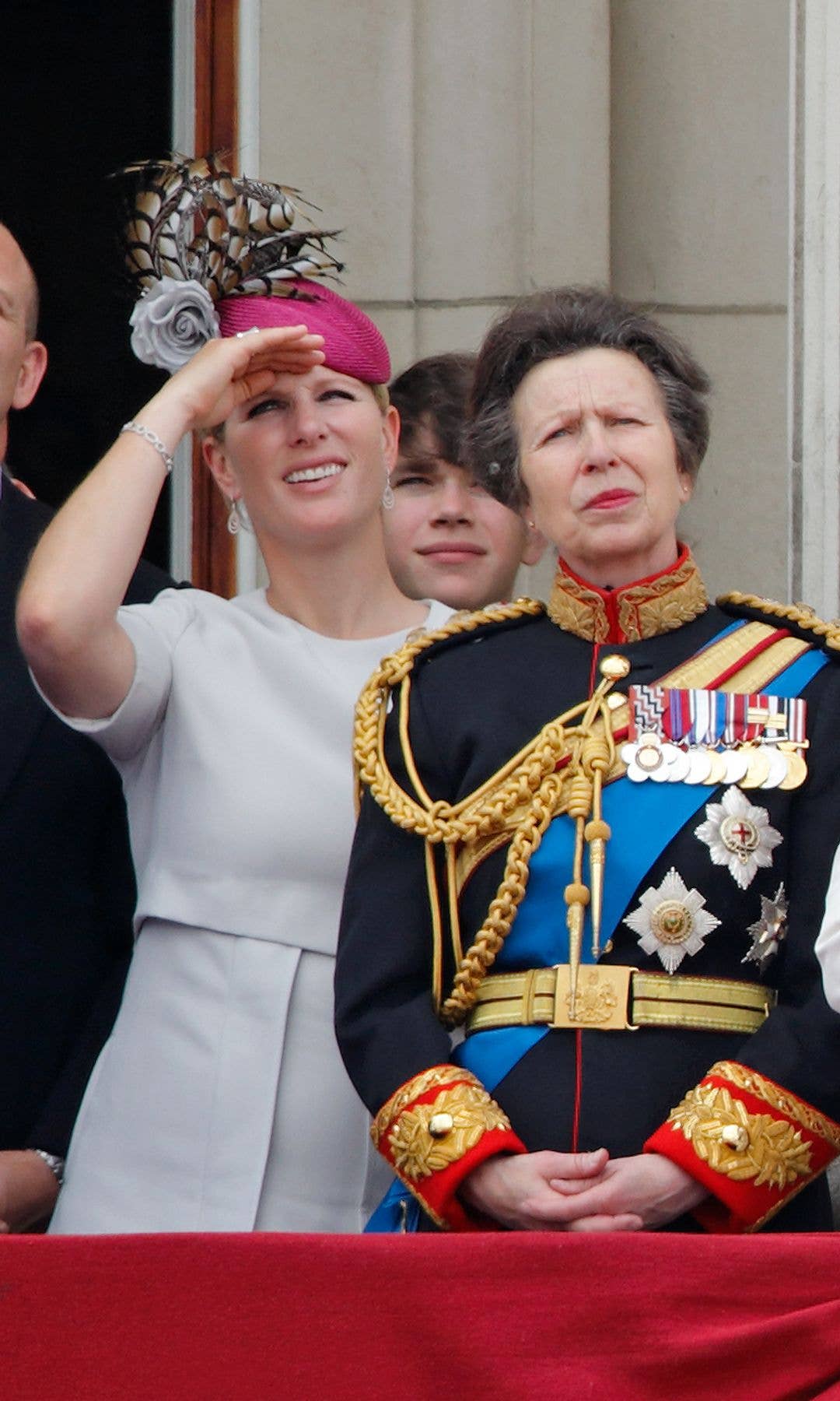 Zara Tindall covering her eyes while standing with Princess Anne