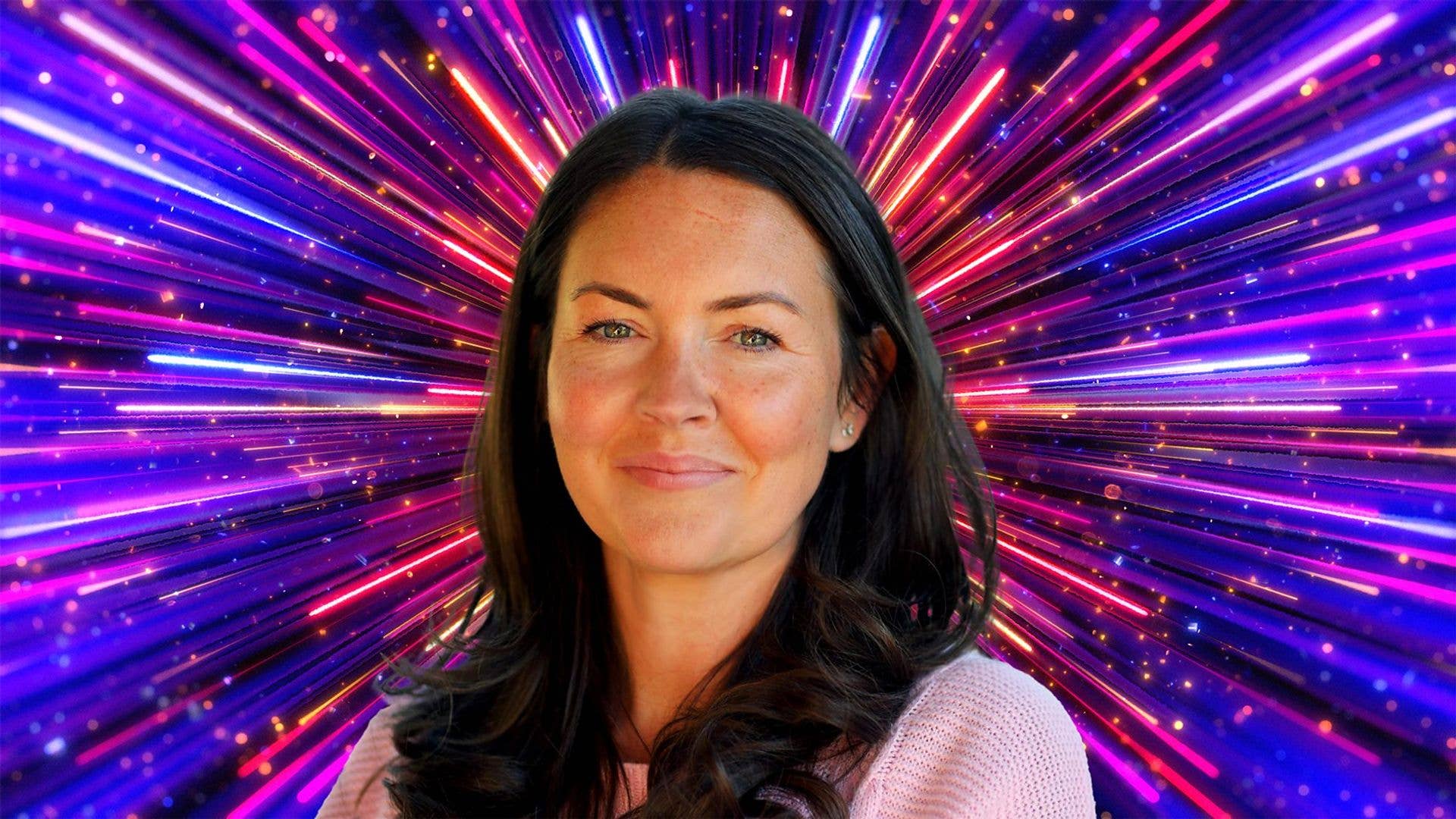 Lacey Turner in front of a glittering background