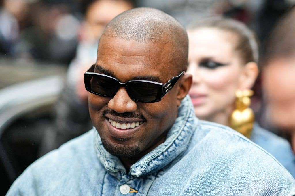 Kanye West smiling wearing sunglasses